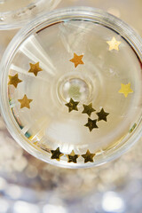 Wall Mural - Glass of champagne with golden stars