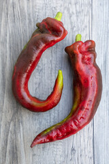 Canvas Print - Vertical shot of chili peppers on a wooden surface