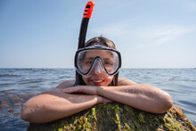 Girl A Diver In The Snorkeling Mask On The Blue Water Background.