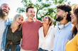 © Davide Angelini - Young happy people laughing together - Multiracial friends group having fun on city street - Diverse culture students portrait celebrating outside - Friendship, community, youth, university concept..
