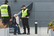 © Photographee.eu - Police officers during patrol next to homeless man sitting on the bench in the city