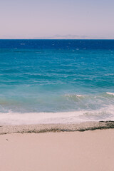 Wall Mural - Beautiful landscape view on sea or ocean with sand, sky and waves.