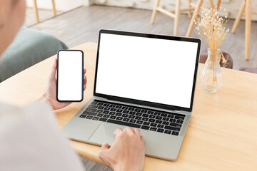 computer screen,cell phone blank mockup.hand woman work using laptop texting mobile.white background for advertising,contact business search information on desk in cafe.marketing,design