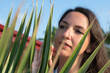 © SYARGEENKA - Young woman near foliage under the sun