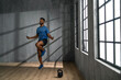 © Halfpoint - Young African American sportsman using jumping rope indoors, workout training concept.