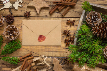 Christmas Composition with a sealed envelope over wooden table flat lay