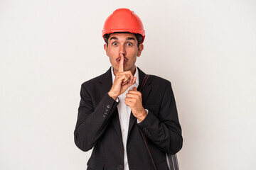 Young architect mixed race man isolated on white background keeping a secret or asking for silence.