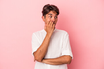 Wall Mural - Young mixed race man isolated on white background biting fingernails, nervous and very anxious.