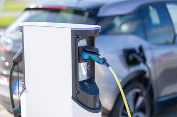 Electric car charging at a station