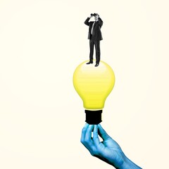 Wall Mural - Female blue hand holding yellow bulb with young man, office worker