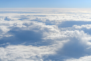 Wall Mural - Clouds and sky as seen through window of an aircraft