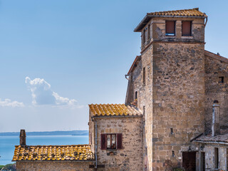 view to buildings of old castle in city Bolsena in Italy with view to lake