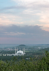 Wall Mural - view of the cloudy sky and islamabad cityscape with the faisal mosque from daman-e-ko, pakistan