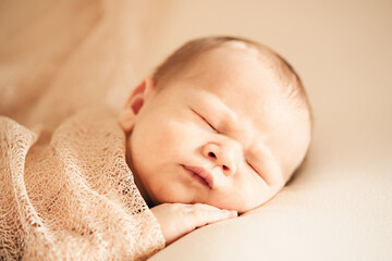 Wall Mural - A newborn baby sleeping on a soft white background. Childhood or parenting concept. Soft focus, copy space.