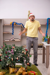 Poster - Young man cleaning the apartment after Christmas party