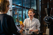 © CandyRetriever  - Asian woman customer using smartphone scanning bar code make contactless payment to barsita at cashier counter in coffee shop. Small business with modern mobile banking electronic payment concept