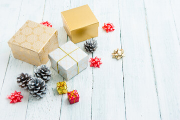 Wall Mural - gift boxes and pine cones on white wooden