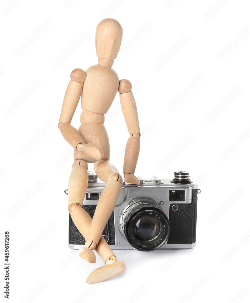 Wooden mannequin with photo camera on white background