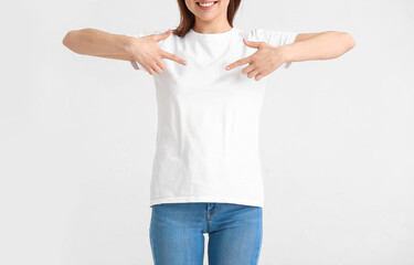 Young woman in modern t-shirt on white background