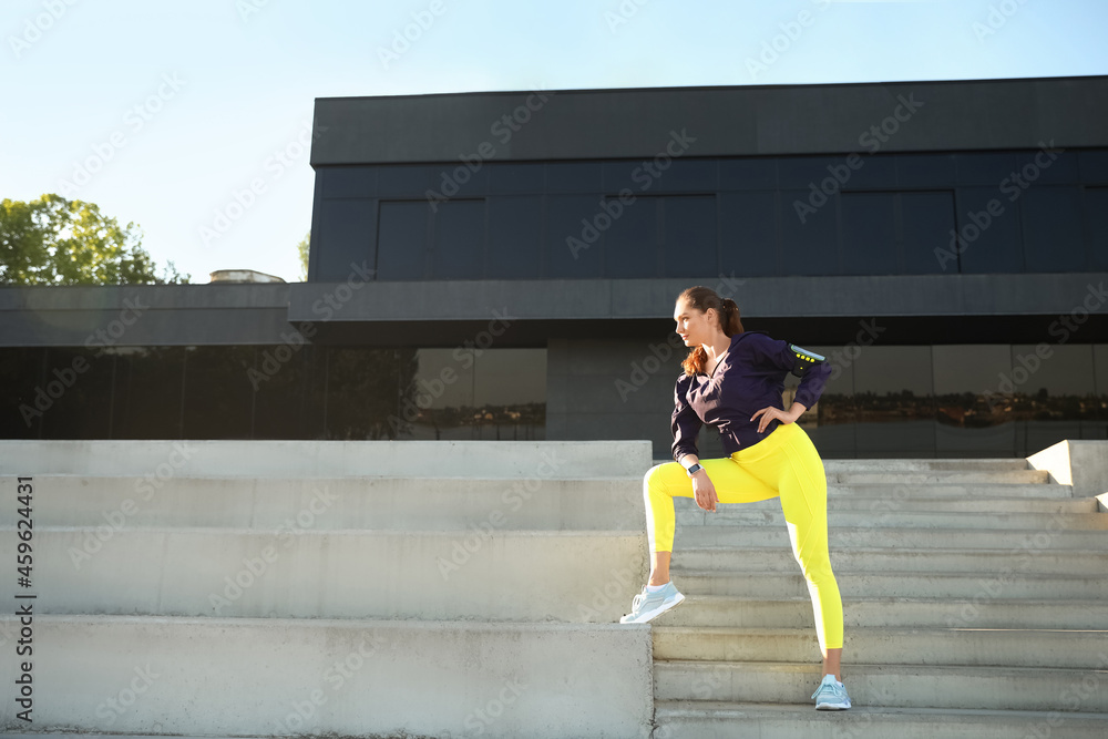 Sporty young woman training outdoors