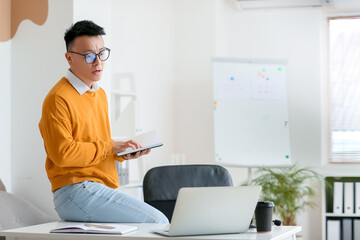 Poster - Asian teacher conducting lesson online in classroom