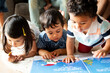 © Rawpixel.com - Children reading a book on the floor