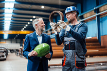 Male Managing Director Discussing With Warehouse Worker In Industry