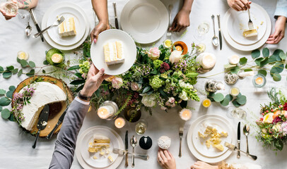 Sharing a slice of cake at wedding reception table