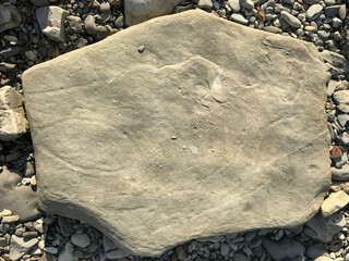 Canvas Print - a large stone lies on a sea pebble on the beach. piece of rock