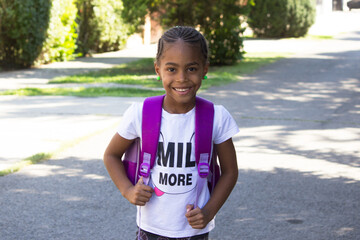 Happy little girl with backpack