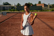 Teen girl with tennis racket on court