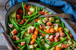Stew dish with green beans, vegetable, sausage, bacon and potatoes