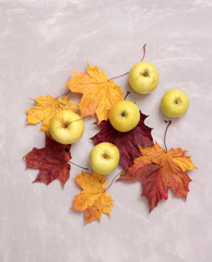 Wall Mural - green apple autumn leaves on a wooden table