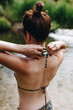 © Westend61 - Woman tying bikini top string