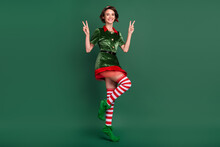 Photo Of Pretty Charming Young Woman Dressed Elf Costume Showing Two V-signs Smiling Isolated Green Color Background