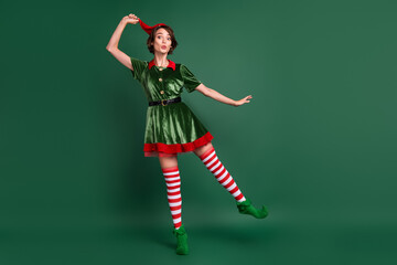 Poster - Full length body size view of attractive cheerful amazed funny girl elf fooling having fun isolated over green color background