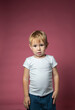 © галина шарапова - Caucasian boy 3 years old makes faces while looking at camera on pink background