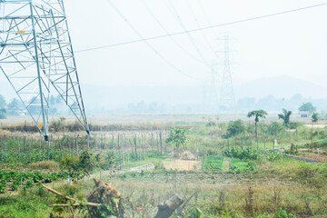 A large high-voltage electric pole located in the midst of nature.