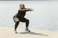 Afro-american Plus Size Woman Doing Yoga Outdoor Near The Lake