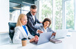 © Westend61 - Businessman explaining female coworkers over laptop in office