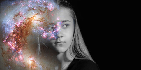  Piercing gaze of young woman through starry sky on black background. Banner, copy space. Concept of paranormal abilities, clairvoyant.  Elements of this image furnished by NASA.