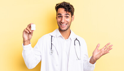 Wall Mural - hispanic handsome man feeling happy, surprised realizing a solution or idea. physician bottle pills concept