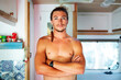 © Westend61 - Confident shirtless man standing with arms crossed in motor home