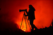 © ADDICTIVE STOCK - Woman silhouette of a photographer and in the background a lava explosion in La Palma Canary Islands 2021
