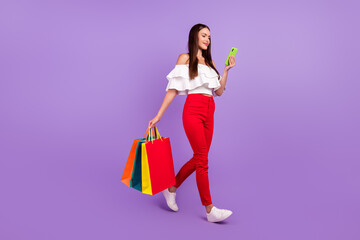 Poster - photo of lady enjoy walk hold phone bargains retail wear white blouse pants sneakers isolated purple