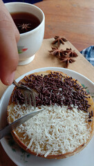 Poster - Close lookup of someone slicing pancakes with sprinkles, with a cup of tea