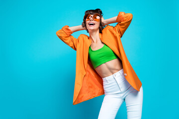 Poster - Photo of positive cool joyful young woman hand head copyspace dance good mood enjoy isolated on blue color background