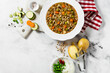 Italian minestrone soup with vegetables and beans on a marble white table
