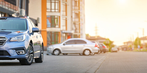 Sticker - Panoramic view of new shiny expensive car parked on city street side.