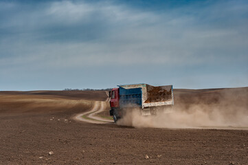 Old truck driving on ground road